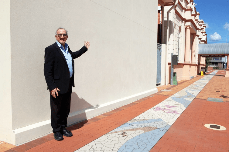 Image: Cr Anthony Michael in front of the blank canvas in Evans Street, Inverell
